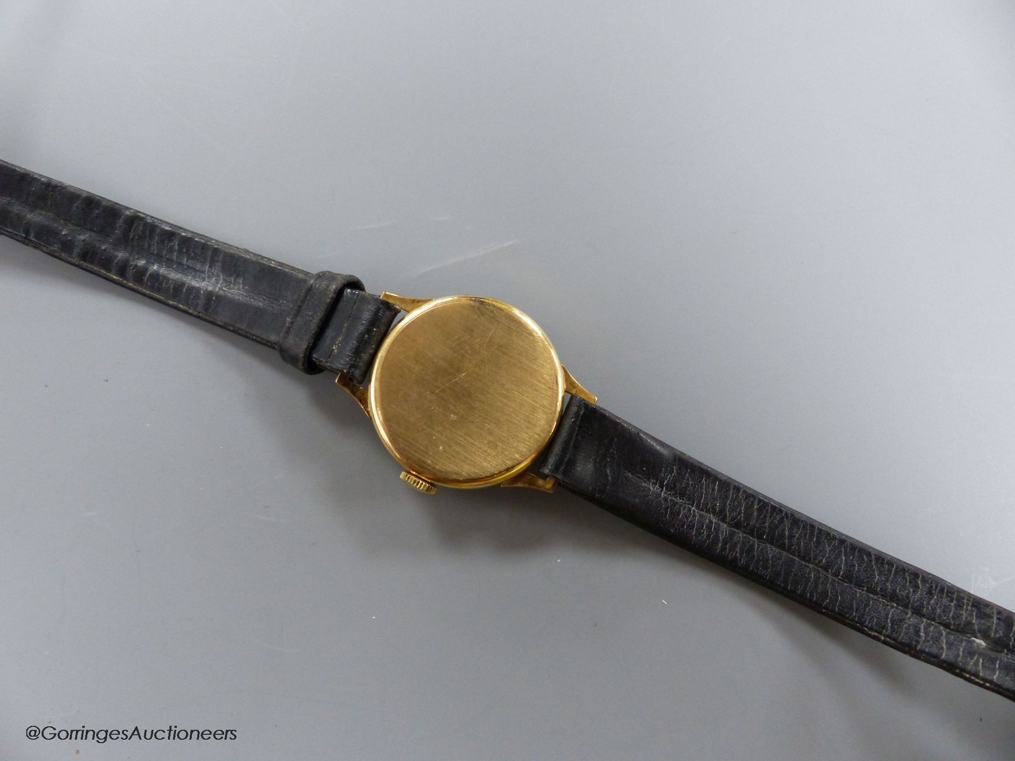 A lady's 9ct gold Tudor manual wind wrist watch, with subsidiary seconds, on a leather strap, with gold plated Rolex buckle, with Tudor box.